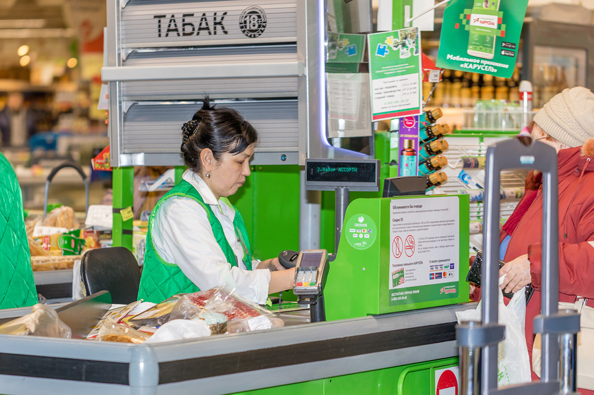 Кассир пробивает товары в супермаркете "Карусель"